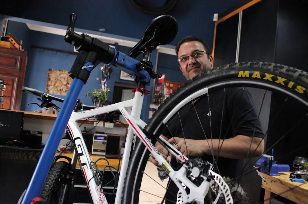 Neil Neethling at the workstand with a mountain bike at Neilson Cycles.