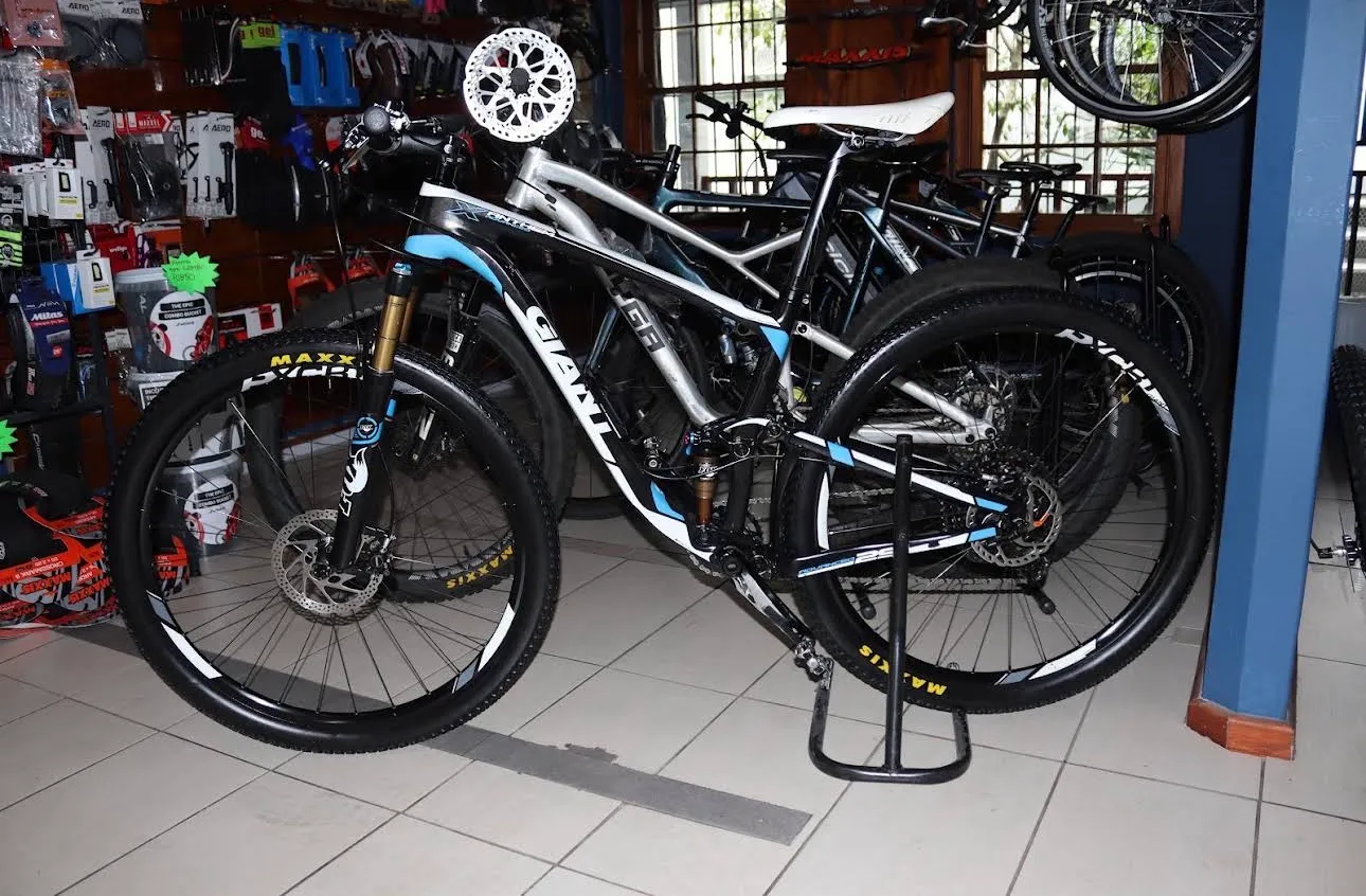 Mountain bikes on the shop floor at Neilson Cycles, with parts and accessories on the walls.